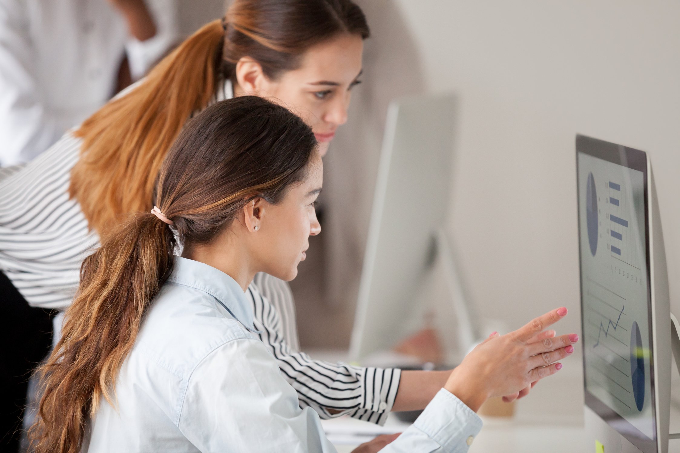 Female coach consulting employee on business issues